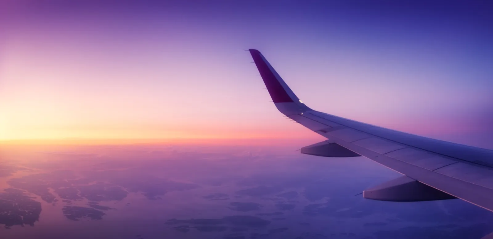 View across an aircraft wing at sunrise