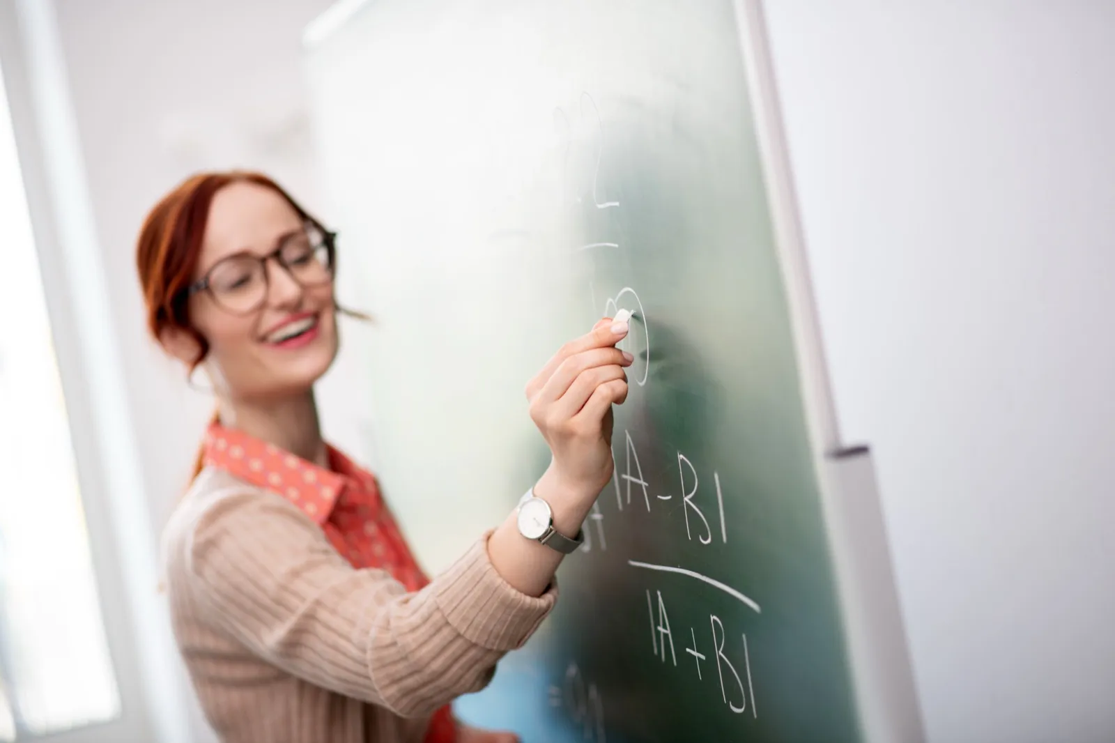 Trainer writing on a chalkboard during a session