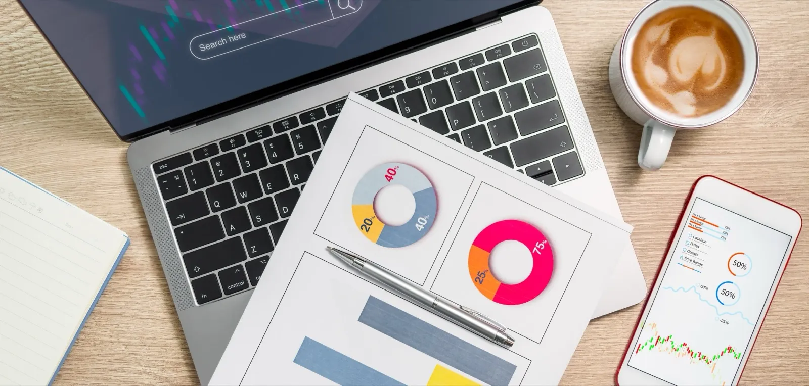 Business analytics on devices across a wooden desk