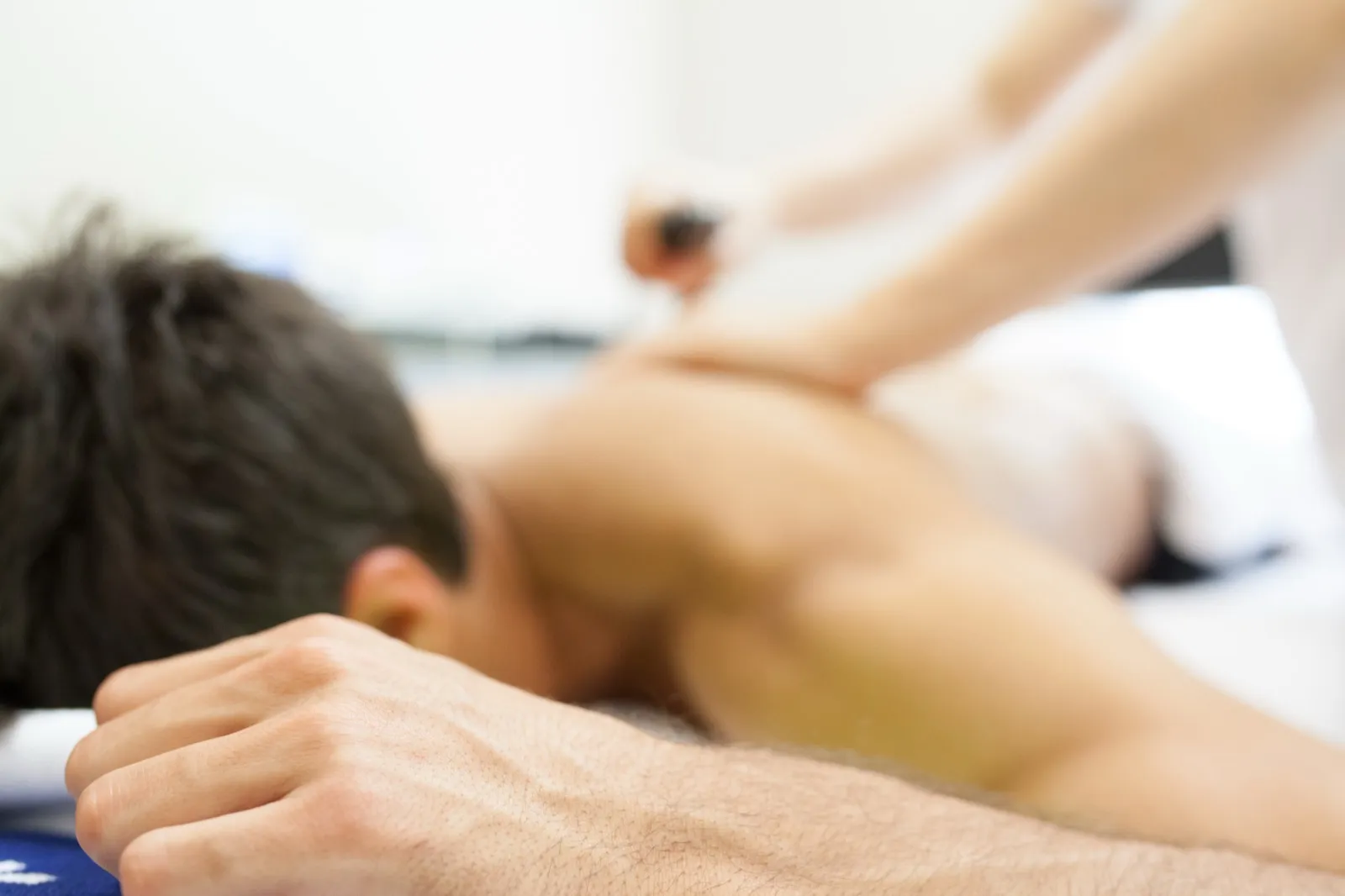 Practitioner giving a therapeutic massage treatment