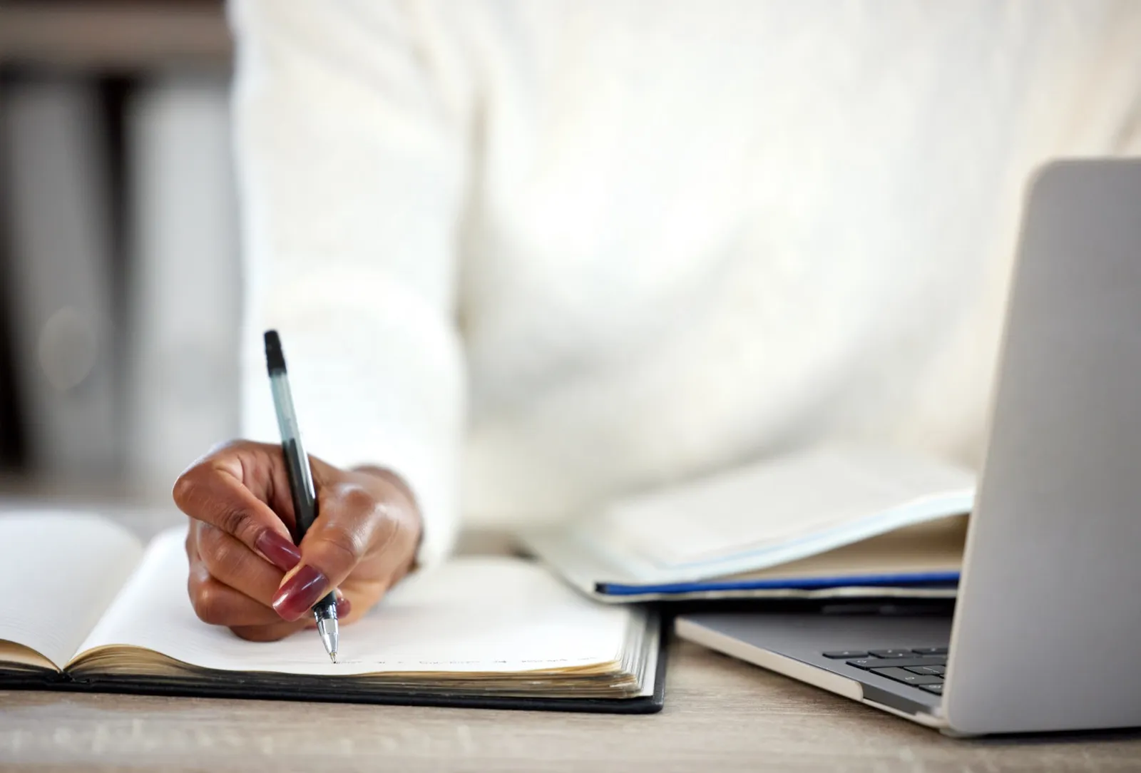 Writer working at a desk with a notebook
