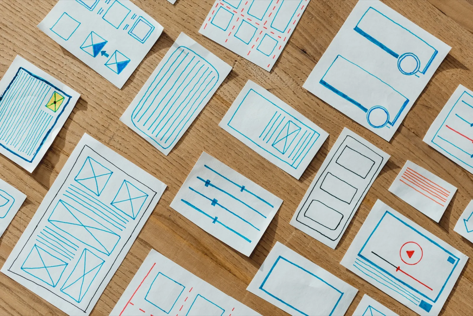 User experience design layouts spread across a desk